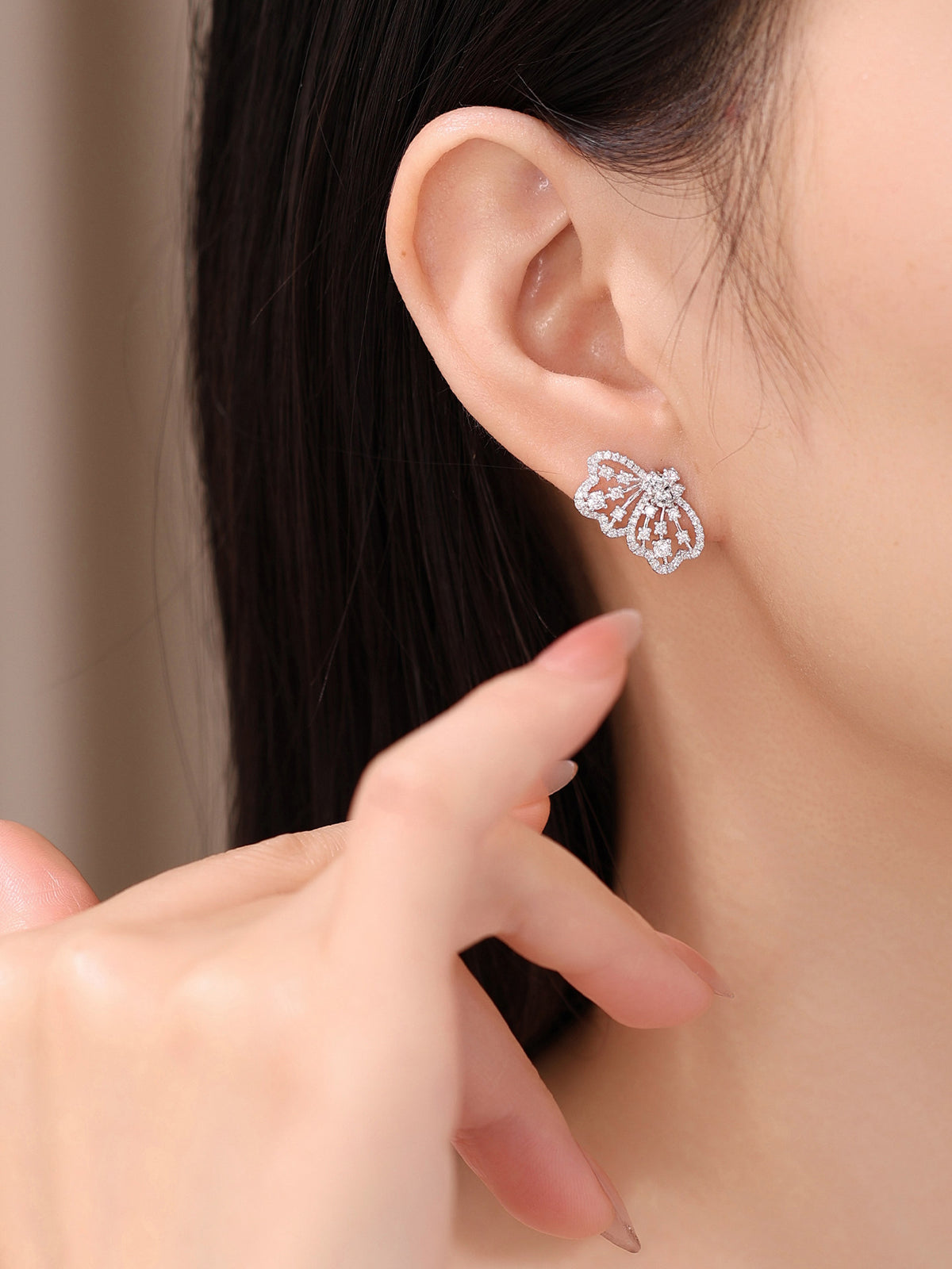 Model wearing Papillon butterfly lab-grown diamond stud earring