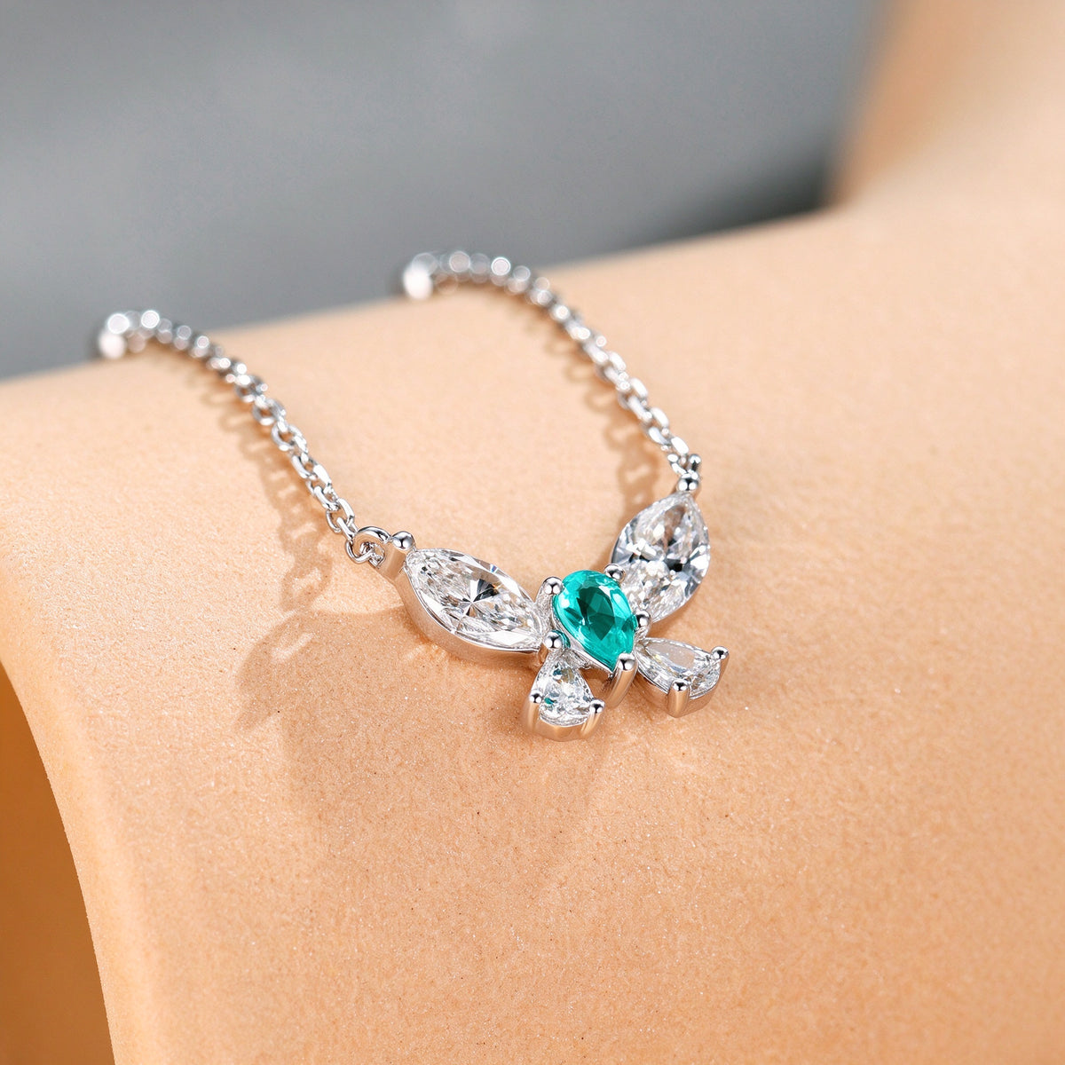 Close-up of the Paraiba-blue pear centre stone and marquise diamond wings