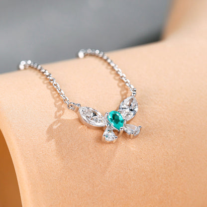 Close-up of the Paraiba-blue pear centre stone and marquise diamond wings