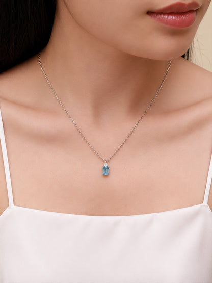 Model wearing the DANFÉE Parfum blue diamond necklace at the collarbone