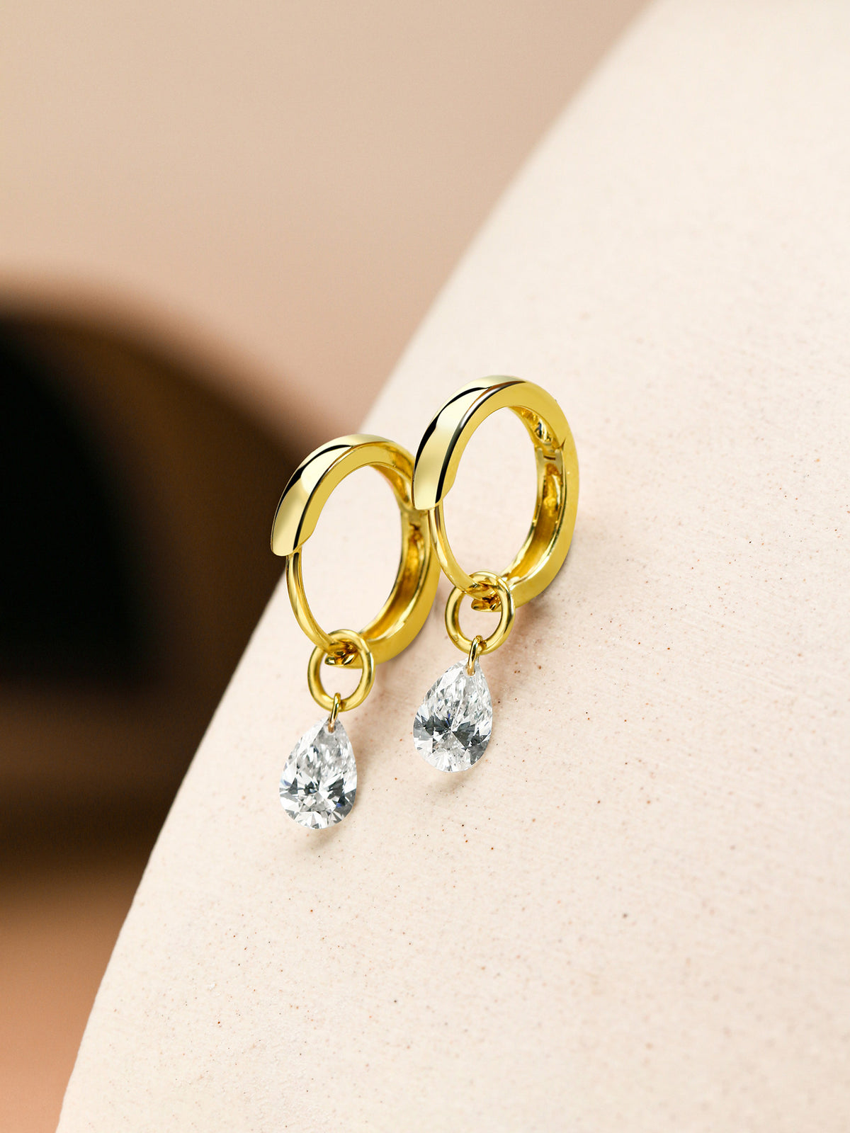 Side view of 18K gold pear-cut lab-grown diamond huggie earrings