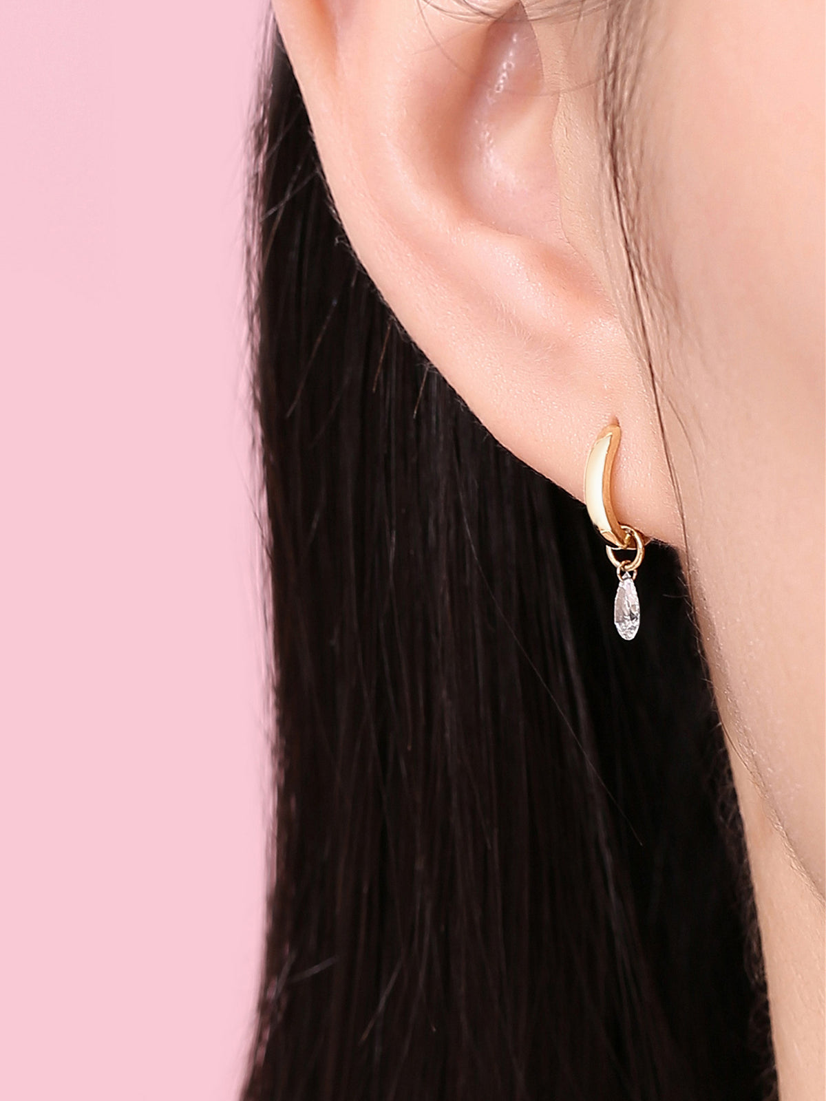 Close-up of the pear-cut lab-grown diamond huggie on the ear