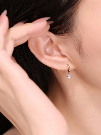 On-ear view of DANFÉE Rosée 18K gold pear diamond huggie earrings