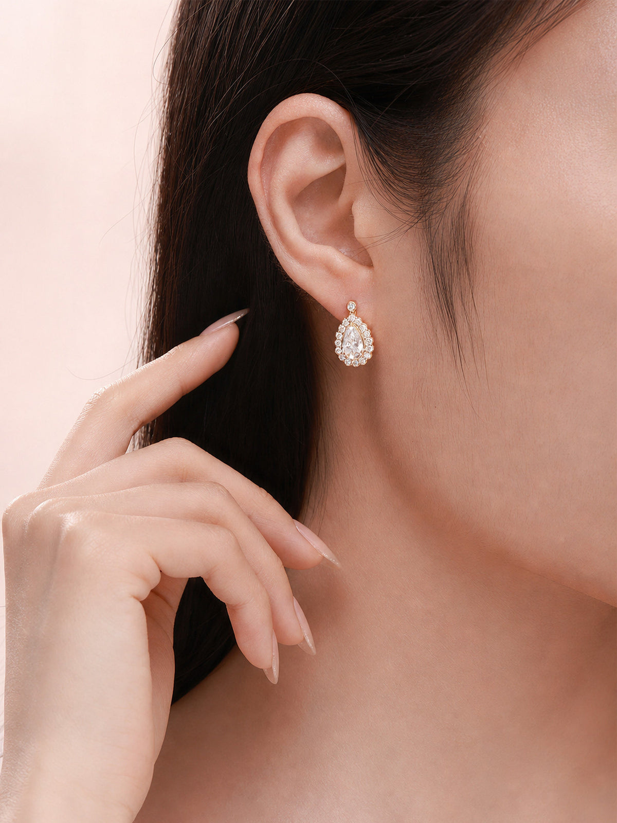 Pear-cut lab-grown diamond halo drop earring worn on the ear