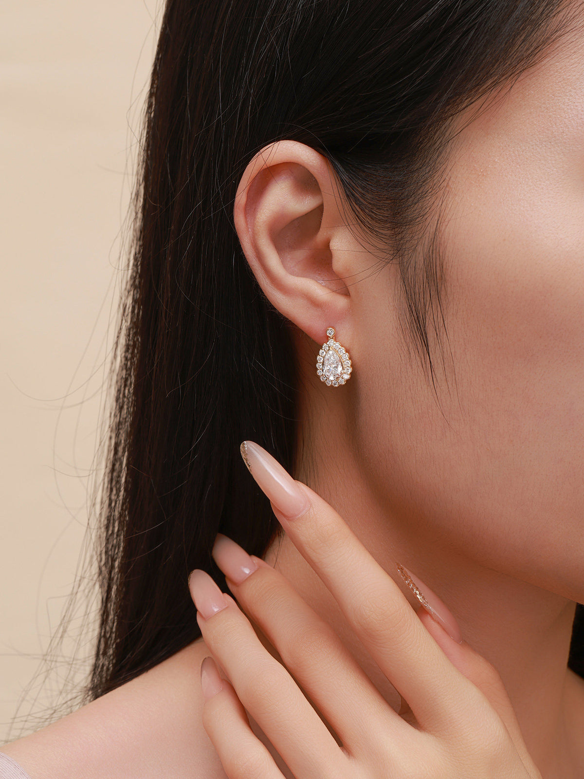 18K gold pear-cut diamond halo drop earring, on-ear scale