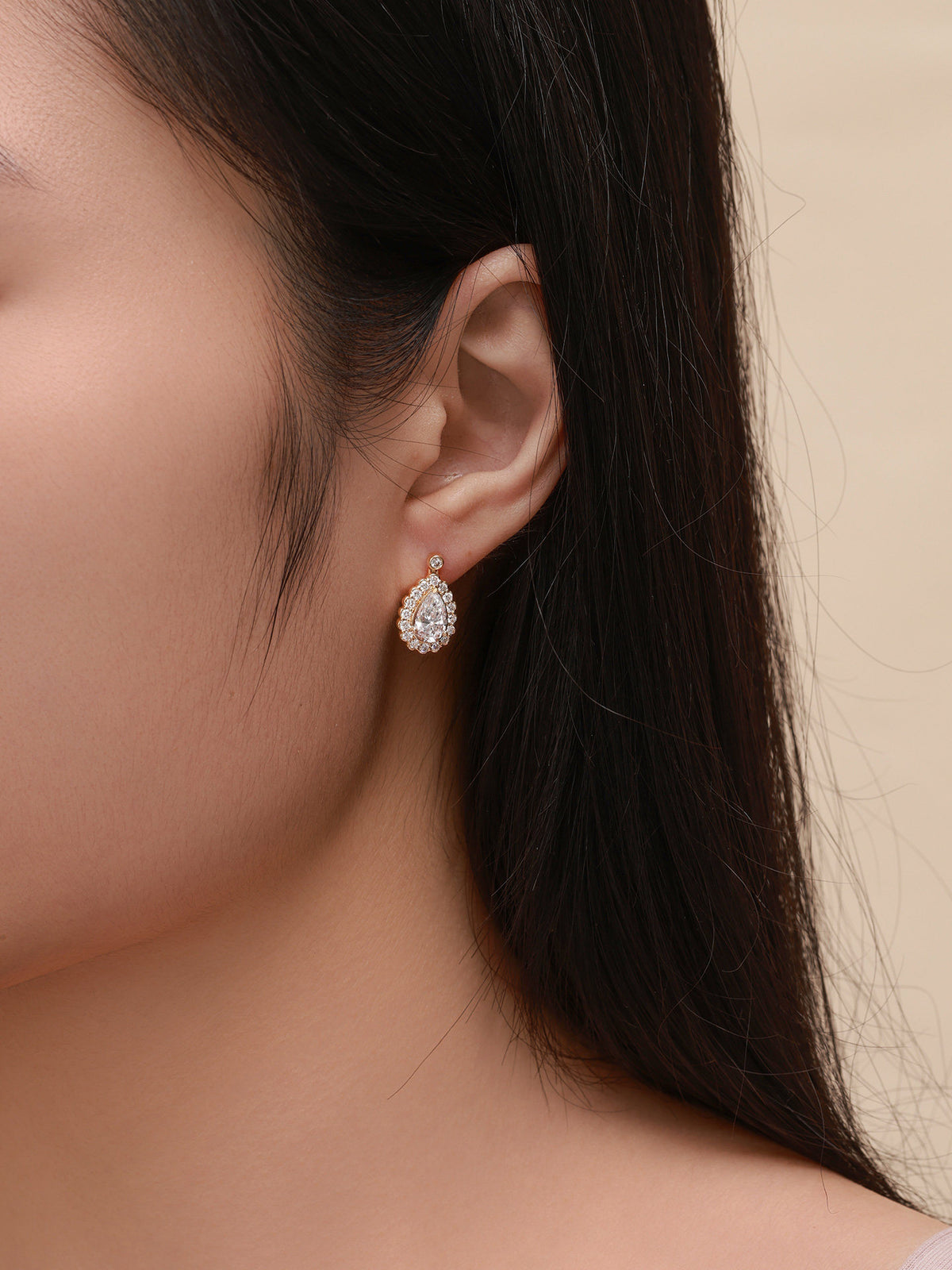 Lab-grown diamond pear halo drop earring worn, side profile