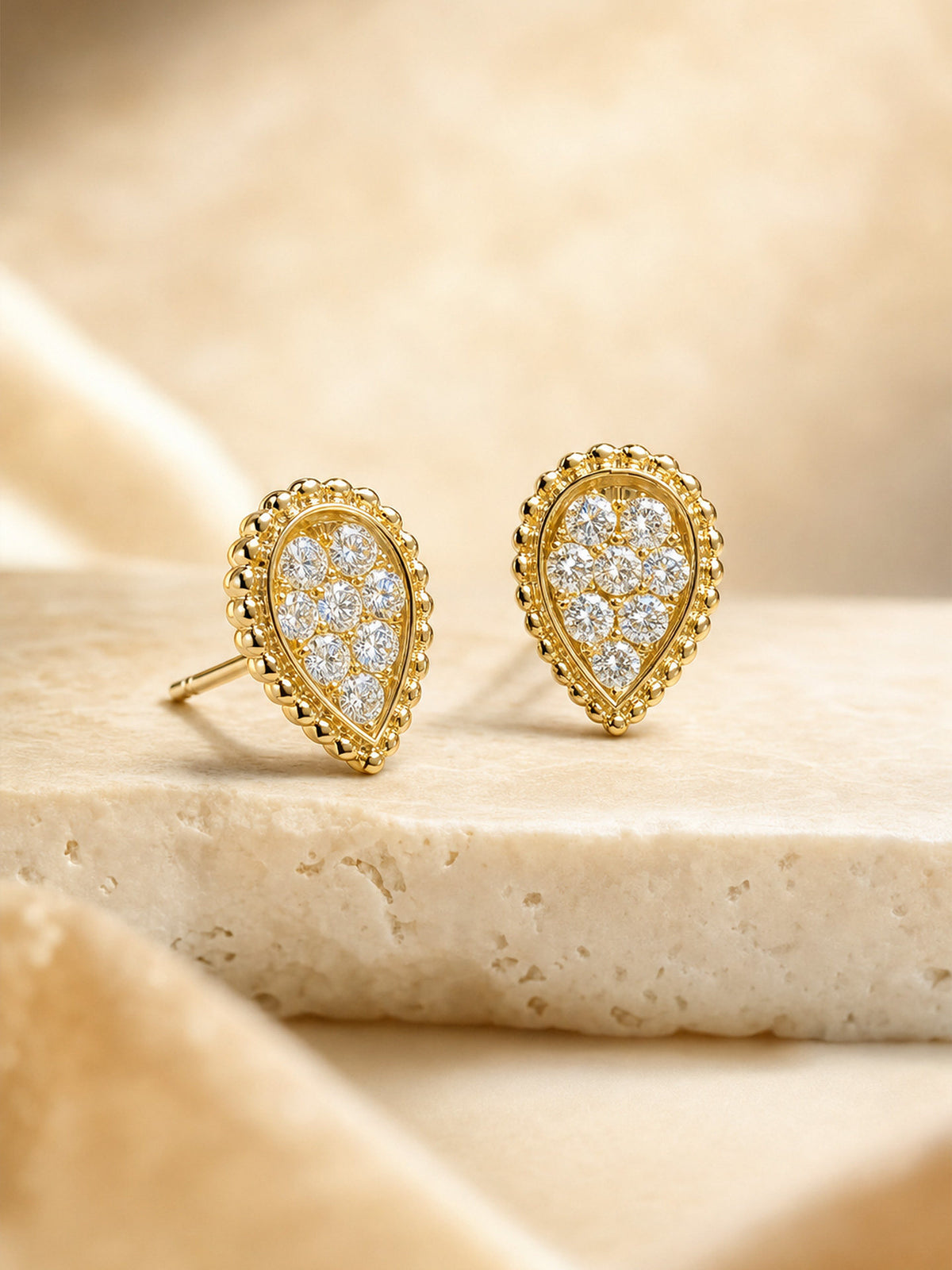 Teardrop pavé diamond stud earrings in 18K yellow gold showing push-back post