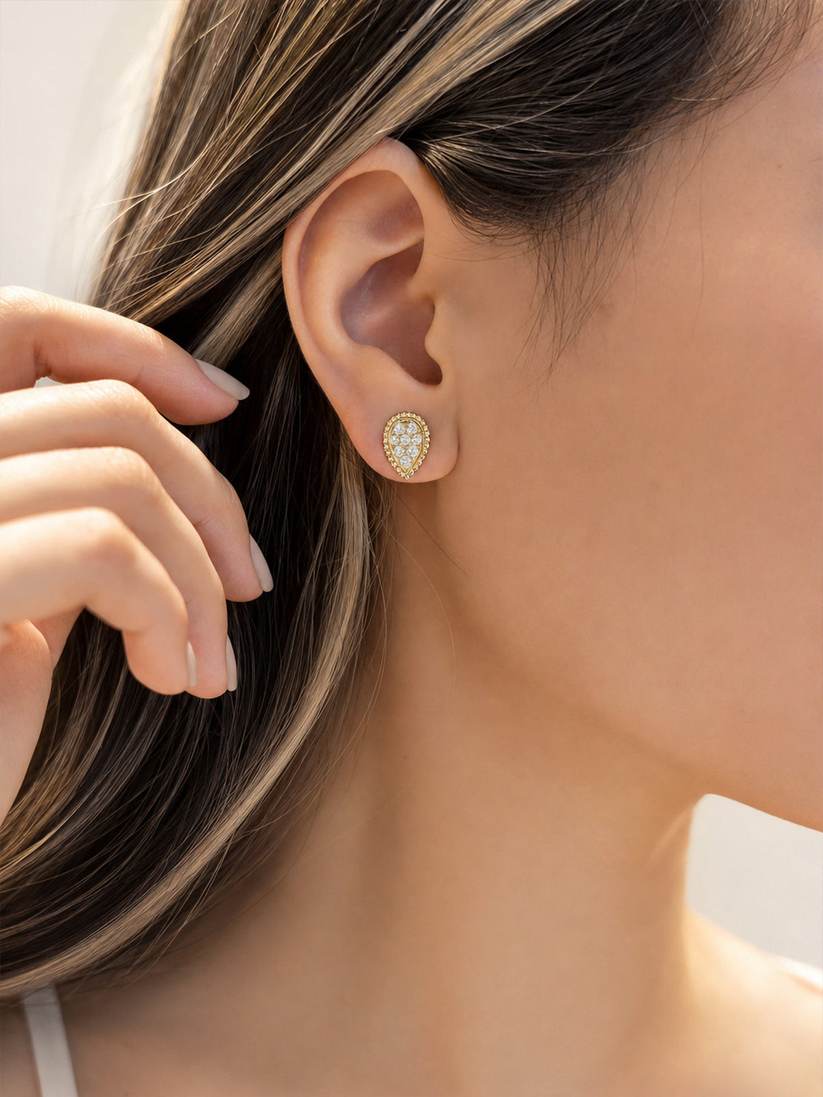 On-ear view of 0.6 carat pear pavé lab-grown diamond stud earrings, D-E VS