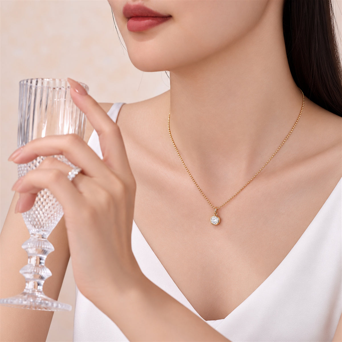 DANFÉE round bezel lab-grown diamond necklace in 18K yellow gold worn with a white V-neck top