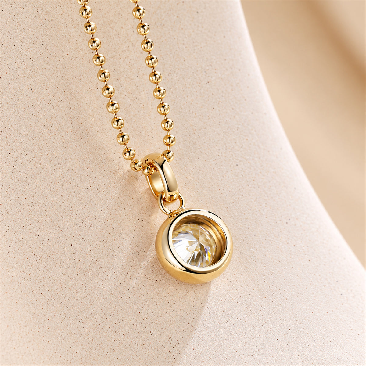DANFÉE round bezel diamond pendant in 18K yellow gold, side view showing open-back setting
