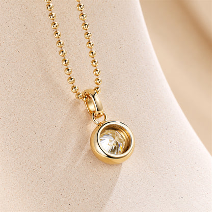 DANFÉE round bezel diamond pendant in 18K yellow gold, side view showing open-back setting