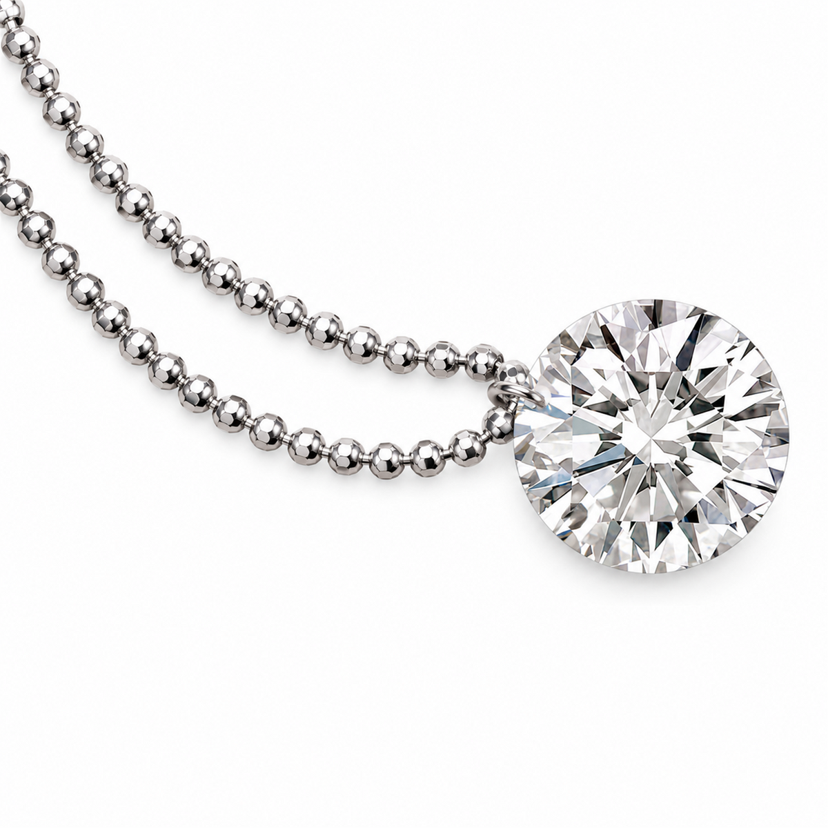 Round diamond pendant and white gold bead chain detail on white; digitally retouched supplier image