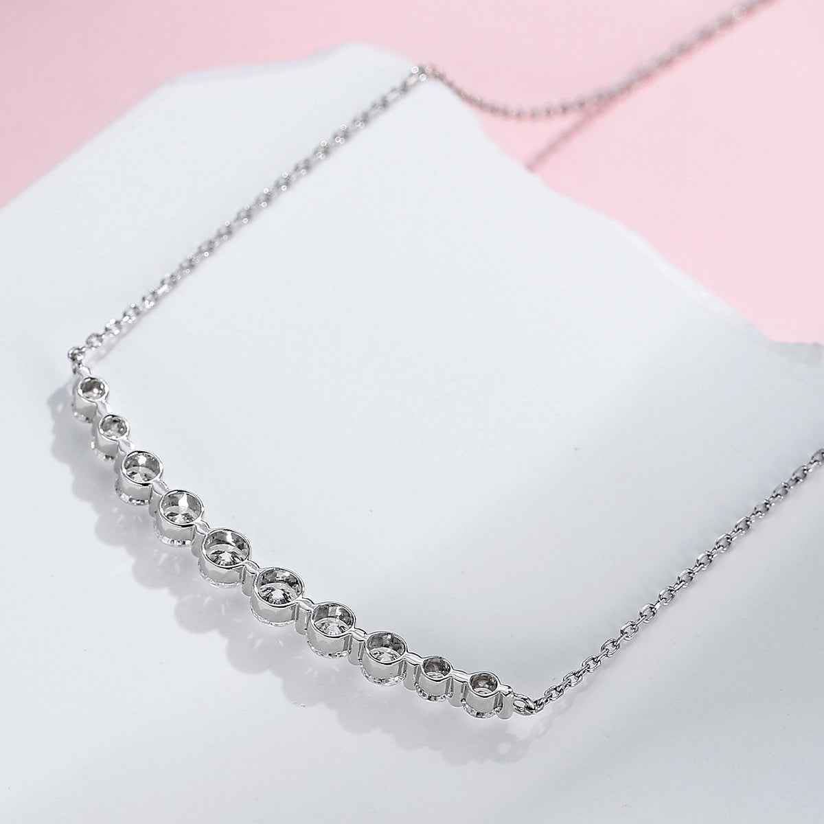 DANFÉE Smile lab-grown diamond necklace resting on a white stone