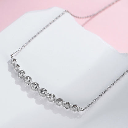 DANFÉE Smile lab-grown diamond necklace resting on a white stone