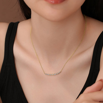Model wearing the DANFÉE Smile diamond bar necklace in 18K yellow gold