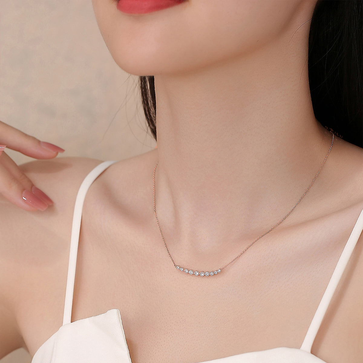 Model wearing the DANFÉE Smile diamond bar necklace in 18K rose gold