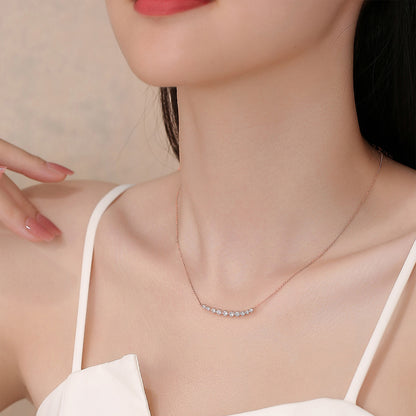 Model wearing the DANFÉE Smile diamond bar necklace in 18K rose gold