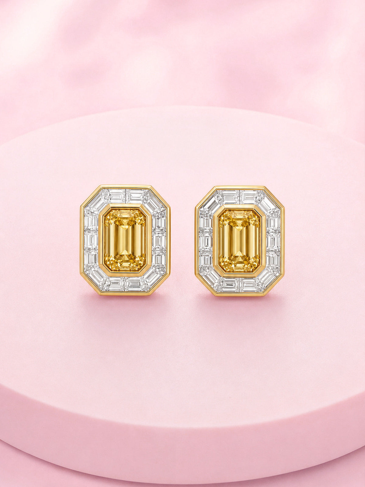Pair of Fancy Intense Yellow emerald-cut diamond stud earrings with baguette halo, front view