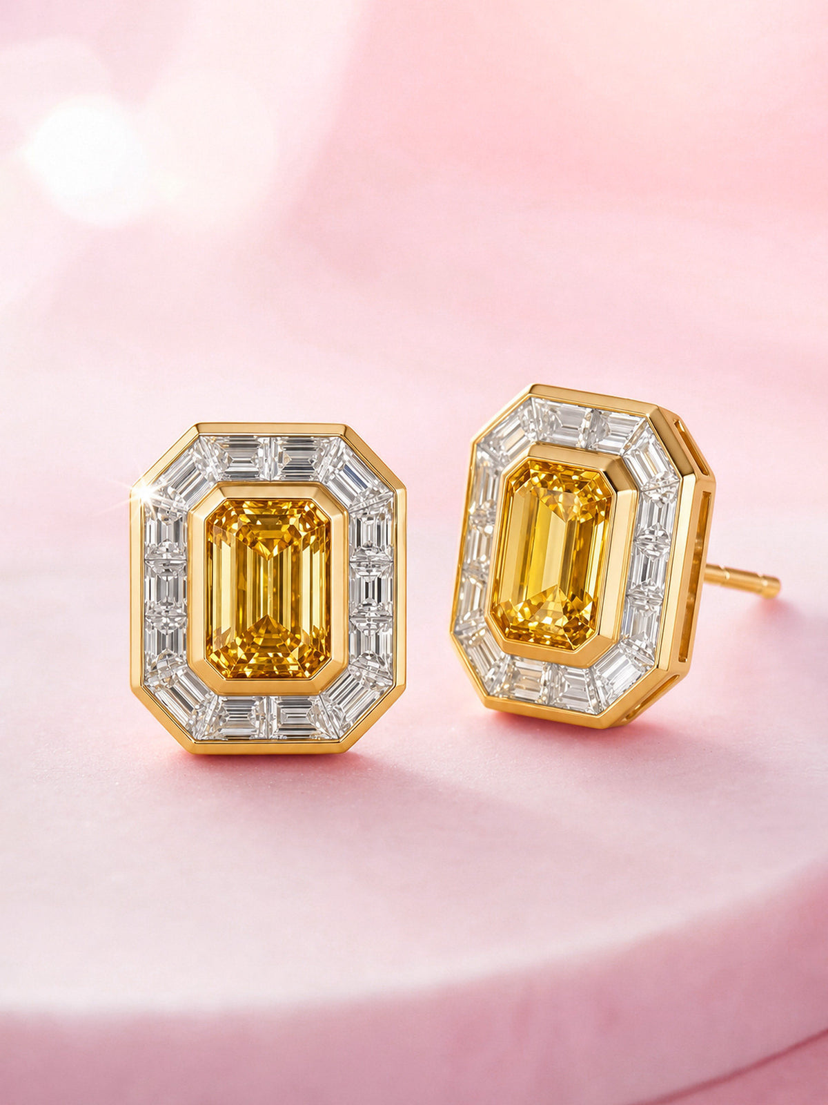 Yellow lab-grown diamond halo stud earrings in 18K gold, angled view