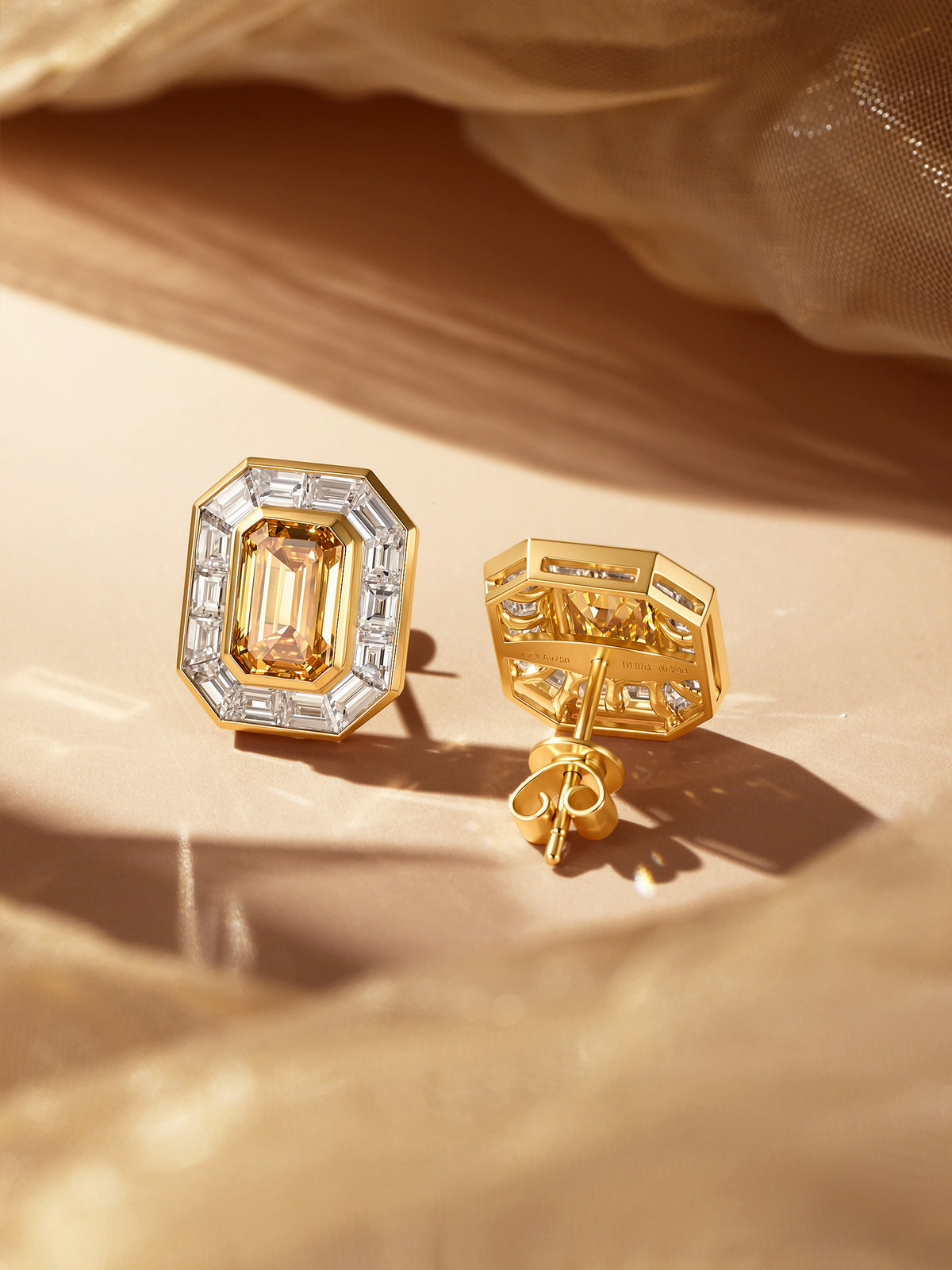 Back of 18K gold halo stud earring showing Au750 hallmark and butterfly back