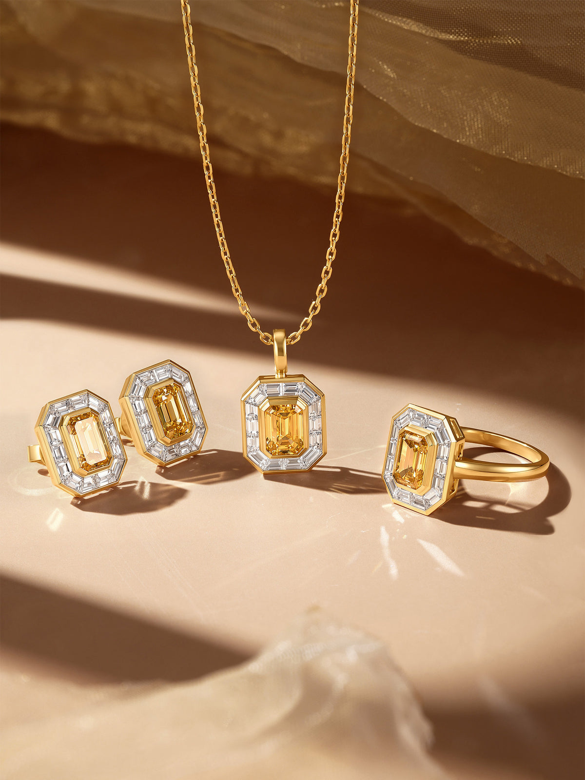 Soleil yellow diamond halo earrings shown with matching pendant and ring