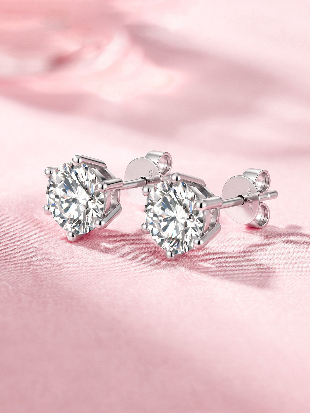 Six-prong lab-grown diamond stud earrings in 18K white gold on pink satin