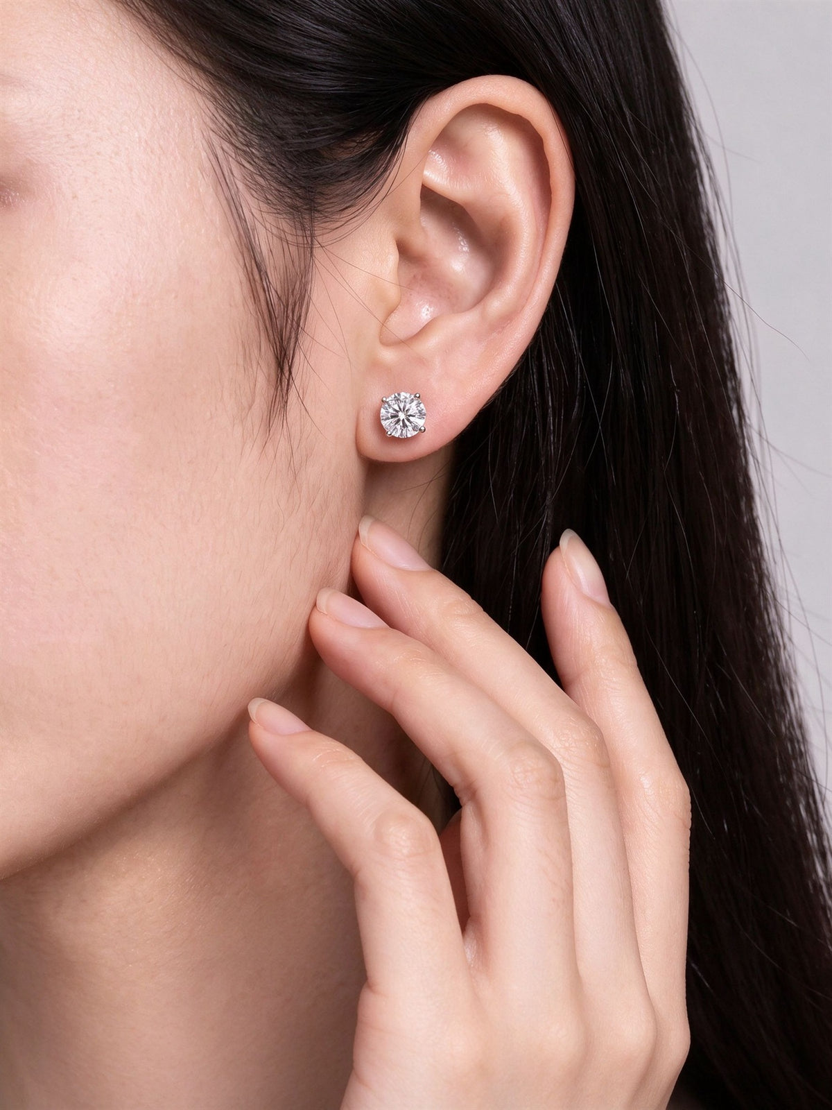 Round lab-grown diamond stud earring worn on the ear