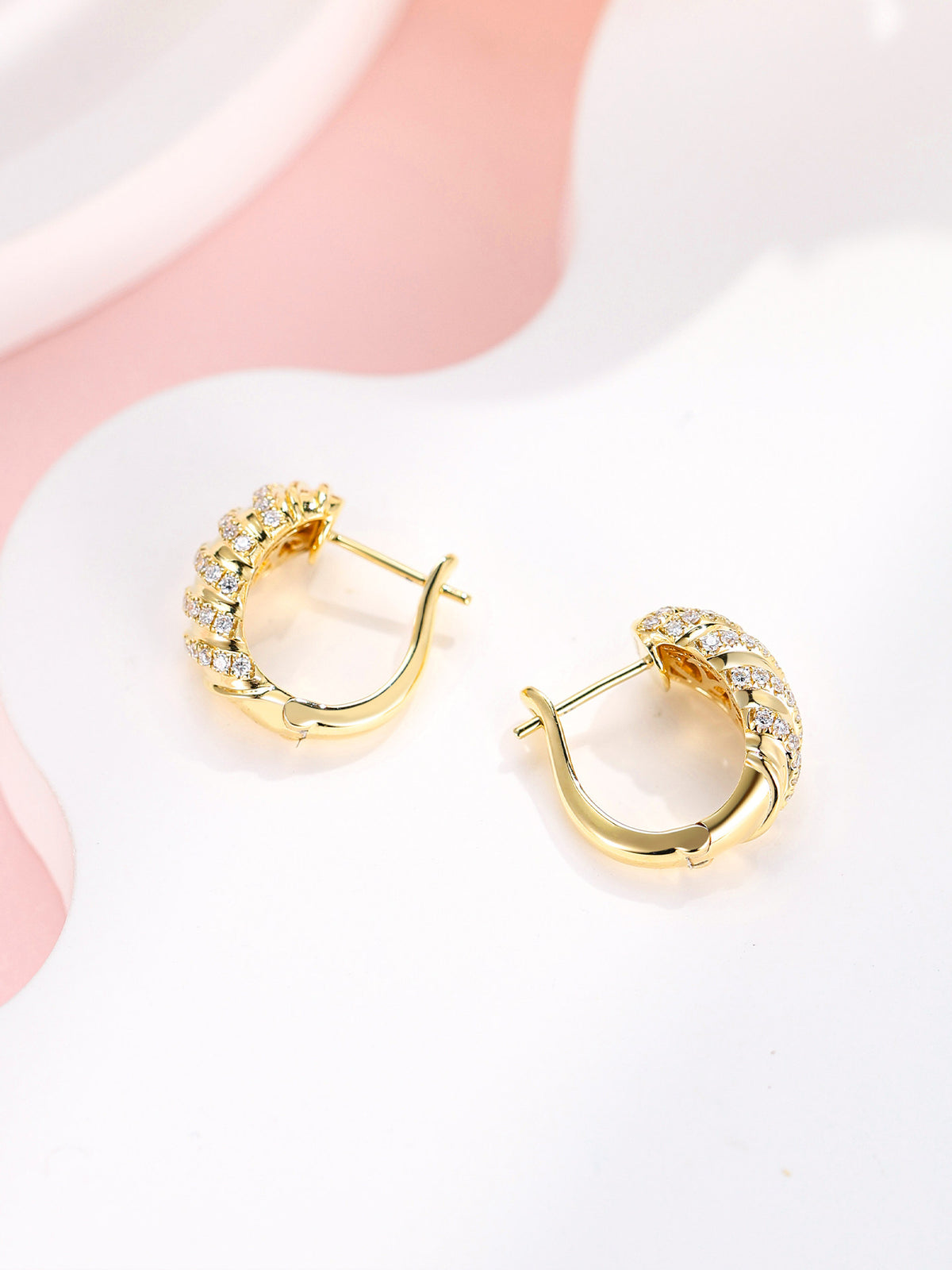 Torsade diamond huggie earrings showing the hinged clasp, 18K yellow gold