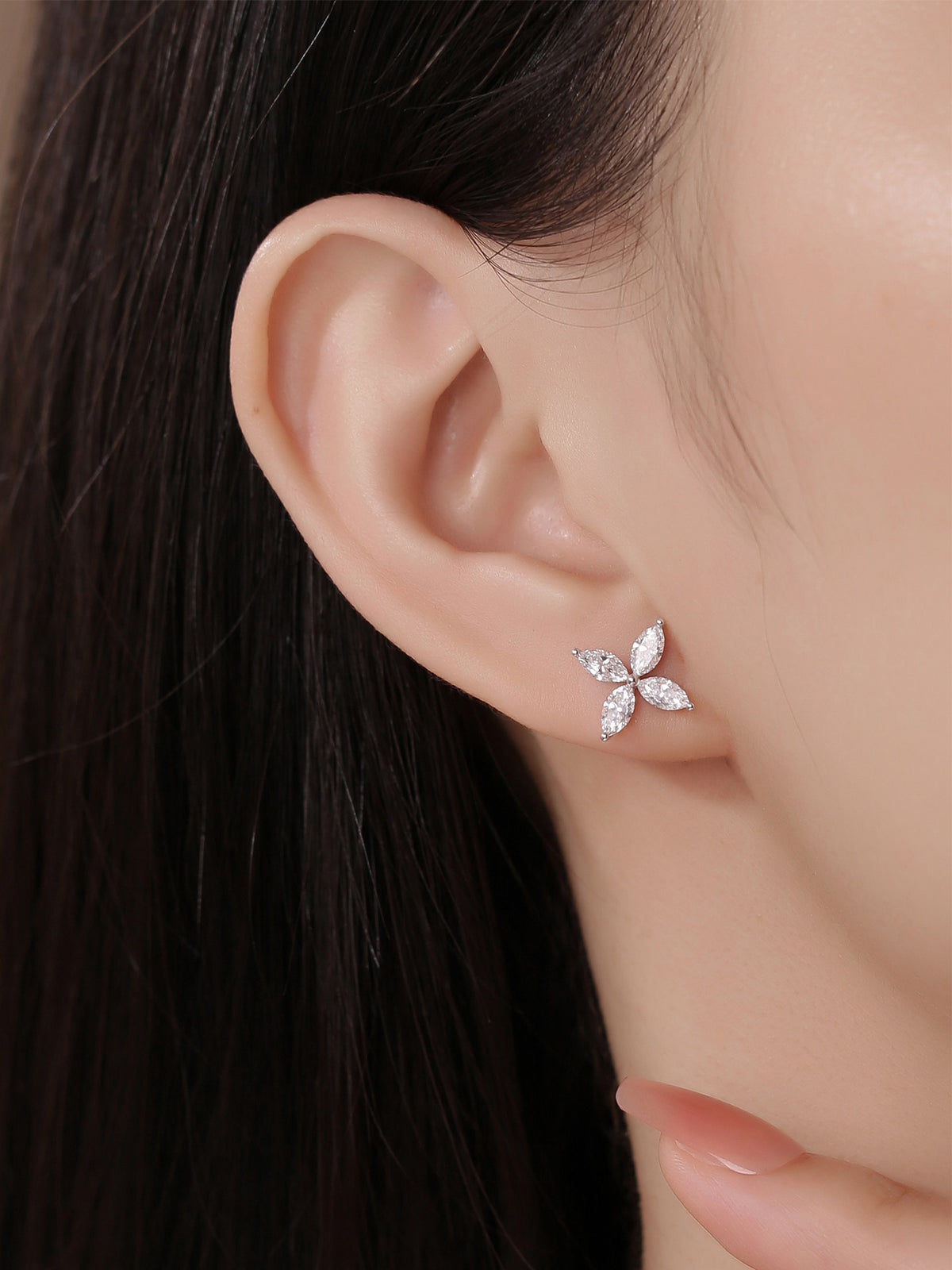 Model wearing the marquise lab-grown diamond clover stud earring in PT950 platinum