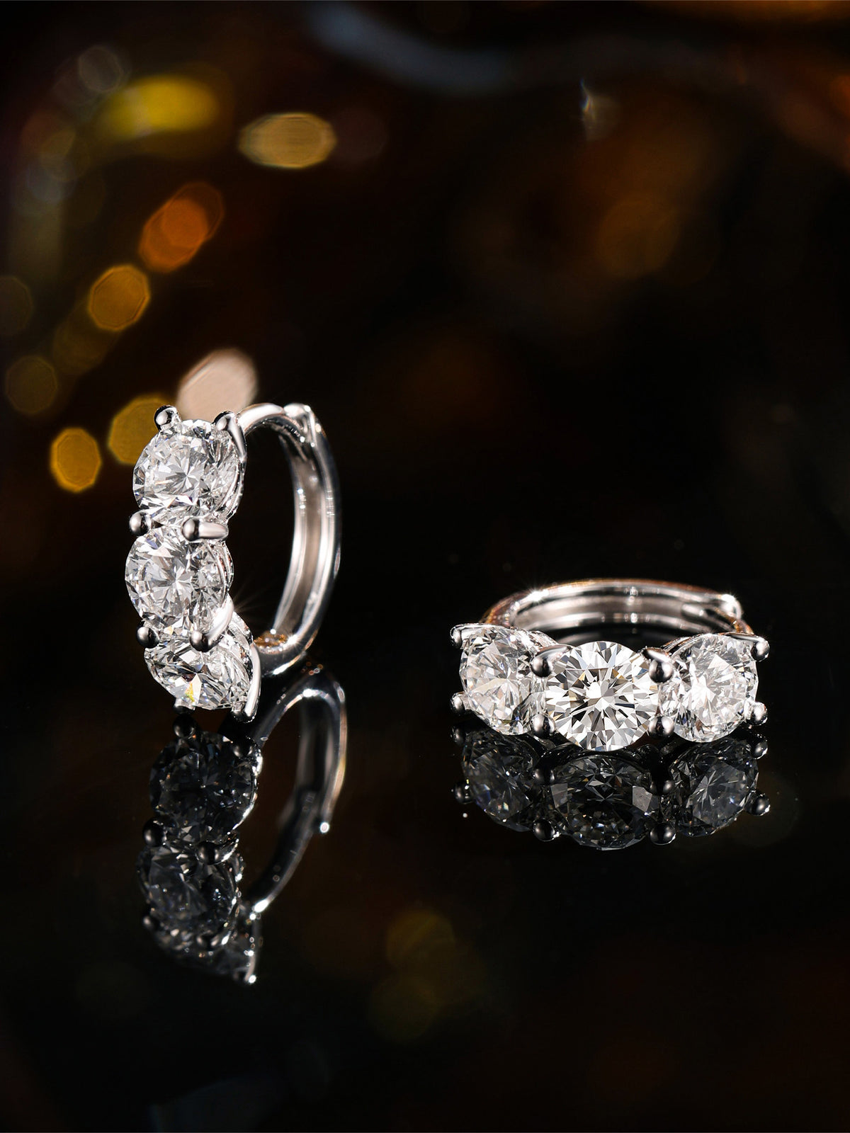 Three round lab-grown diamonds in a shared-claw huggie setting