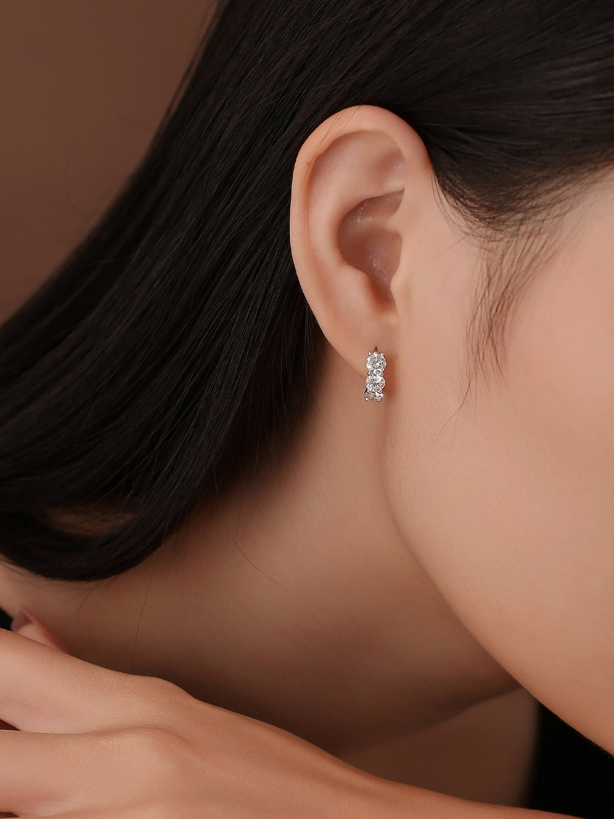 DANFÉE three-stone huggie hoop worn on the lobe
