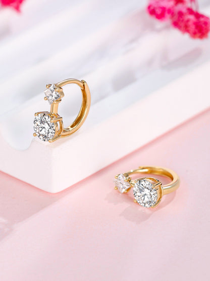 18K gold two-stone lab-grown diamond huggie earrings on a soft pink display