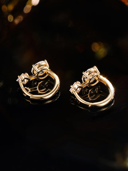 Four-claw settings and hinged hoop of the 18K gold diamond huggie earrings