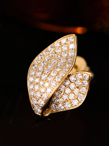 Close-up of micro-pavé lab-grown diamonds on 18K gold leaf earring