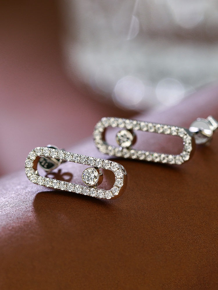 Floating centre diamond paperclip earrings on burgundy leather