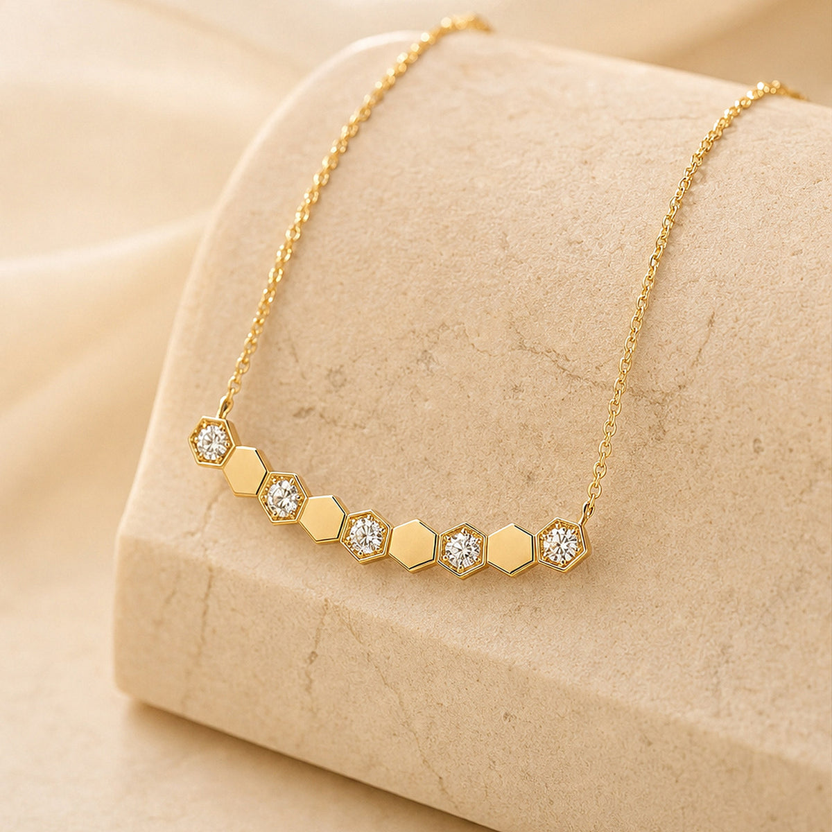 DANFÉE Hive honeycomb diamond necklace displayed on stone