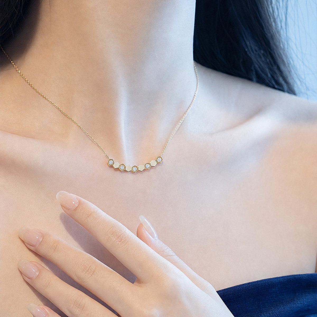 Model wearing DANFÉE Hive honeycomb smile necklace at the collarbone