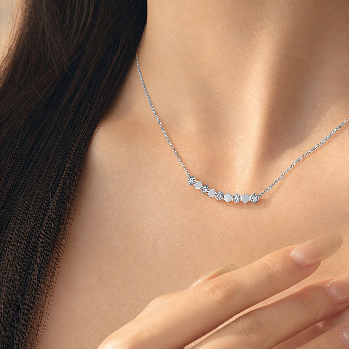 Model wearing DANFÉE Hive hexagon diamond necklace in PT950 platinum