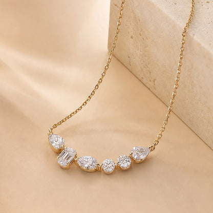 DANFÉE Mosaic Smile 2 carat lab-grown diamond necklace draped over travertine
