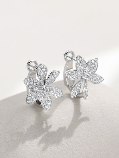 Six-petal pavé diamond flower huggie earrings, angled view