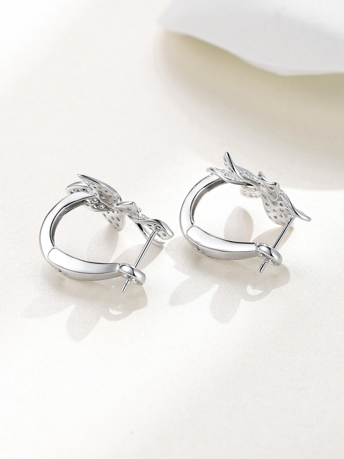 Hinged clip-back and post of the flower huggie earrings