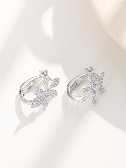 Flower huggie earrings shown open with curved back