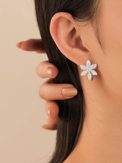 Pavé diamond flower earring on model, side profile