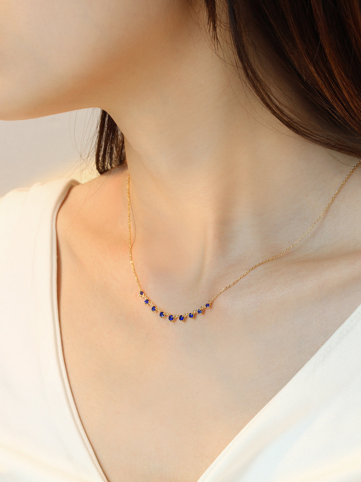 DANFÉE Nine-Stone Smile sapphire necklace worn at the collarbone