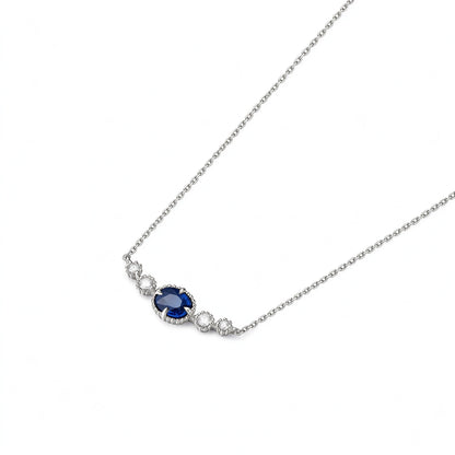 DANFÉE oval sapphire smile necklace, angled view of the four-claw setting and milgrain edges