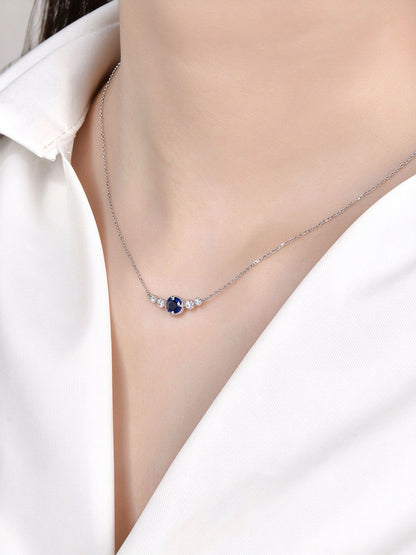 Model wearing the DANFÉE oval sapphire smile necklace at the collarbone