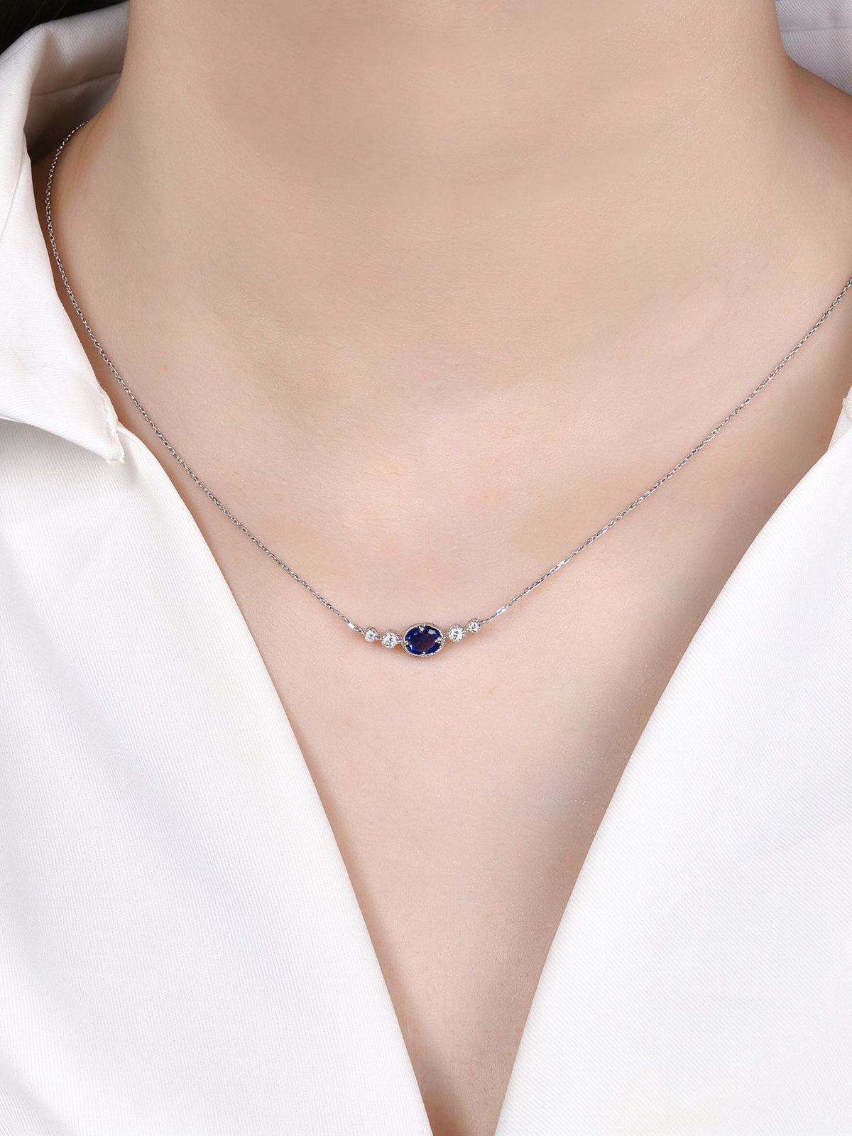 DANFÉE 0.45 carat oval sapphire and diamond necklace on model, front view