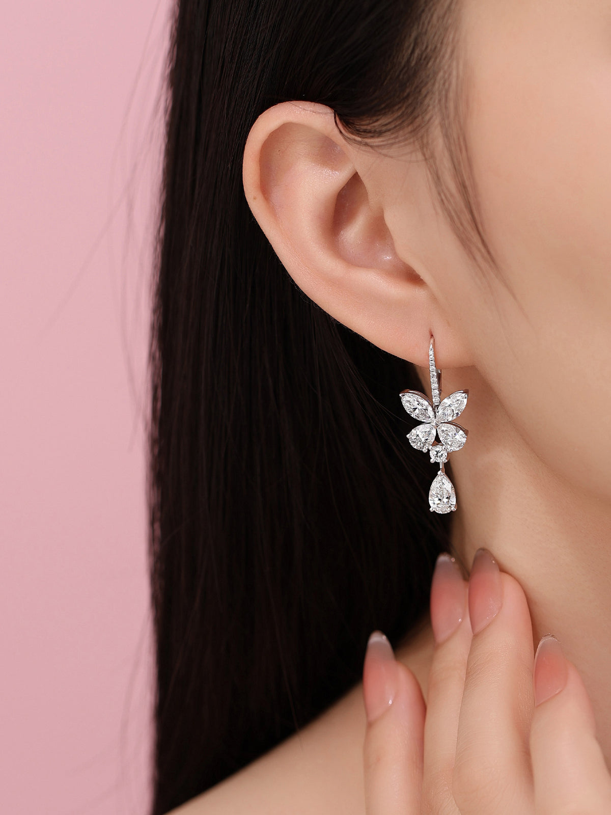 Butterfly pear-drop diamond earring worn on the ear