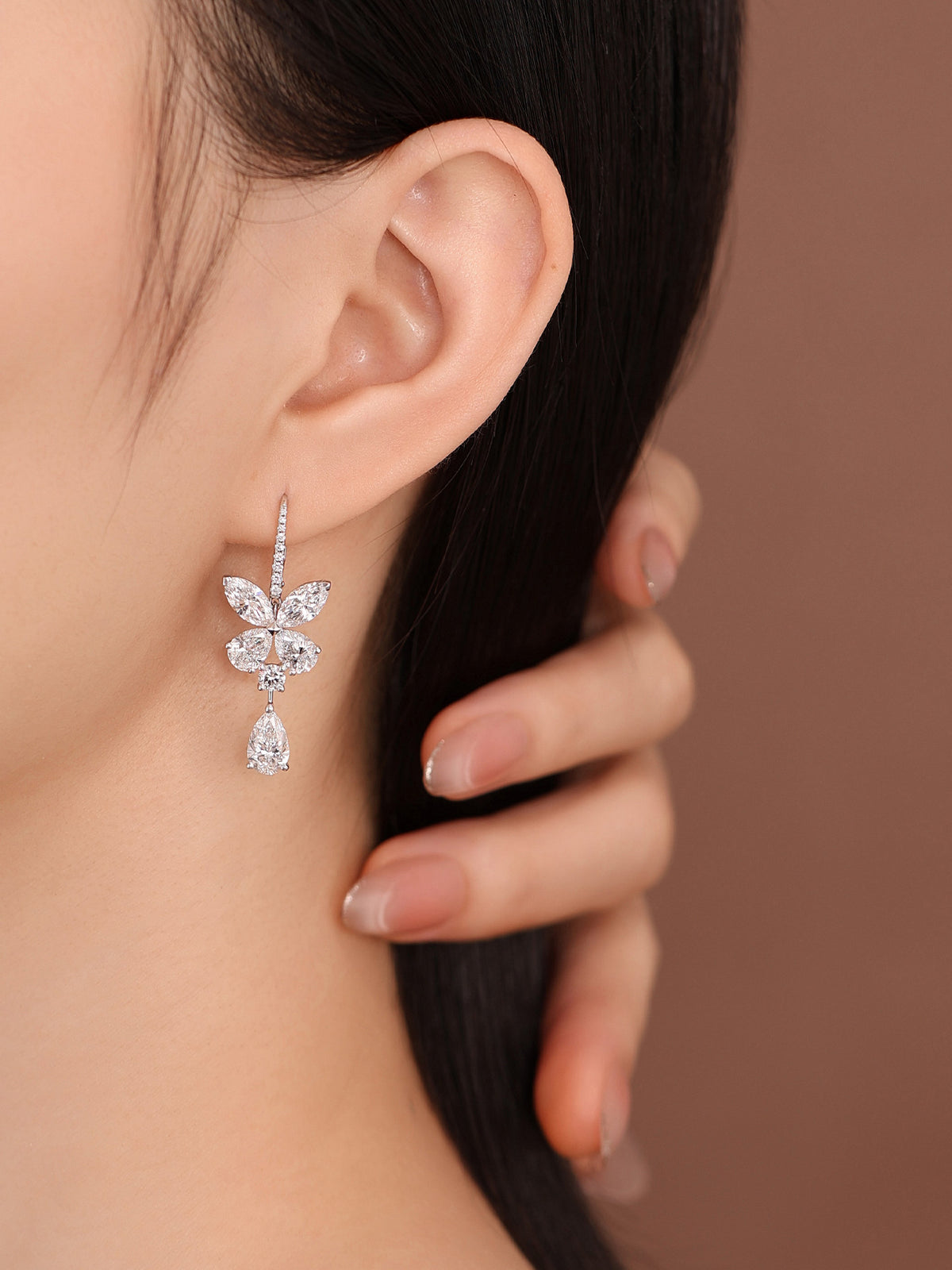 Pavé lever-back butterfly diamond earring on model