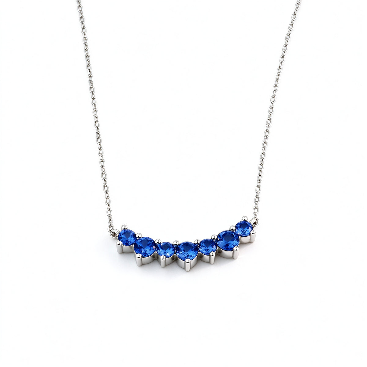 DANFÉE Seven-Stone Smile sapphire necklace, angled view of the claw settings